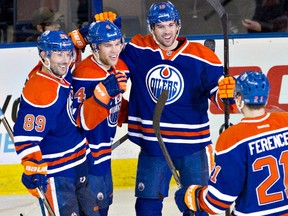 From left, Edmonton Oilers players Sam Gagner, Taylor Hall, Justin Schultz and Andrew Ference celebrate a goal against the Tampa Bay Lightning during  NHL action vs. the visiting Tampa Bay Lightning at Rexall Place on Jan. 5, 2014.