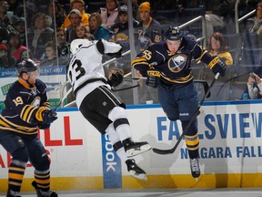 Rasmus Ristolainen checks Dustin Brown (Photo: Bruce Bennett/Getty Images)