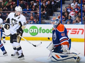 EDMONTON, AB - JANUARY 10:  Devan Dubnyk #40 of the Edmonton Oilers stops the shot of Chris Kunitz #14 of the Pittsburgh Penguins during an NHL game at Rexall Place on January 10, 2014 in Edmonton, Alberta, Canada. (Photo by Derek Leung/Getty Images)
