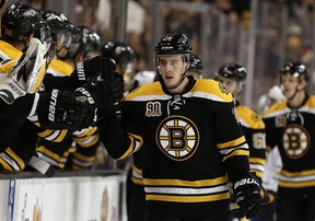 Reilly Smith of the Boston Bruins is congratulated at the bench after scoring against the Buffalo Sabres during an NHL game at Boston on Dec. 21, 2013.
