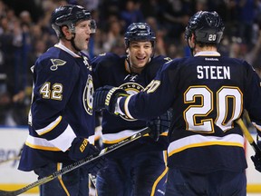Chris Stewart #25, David Backes #42 and Alex Steen #20 all of the St. Louis Blues celebrate Stewart's goal against the Phoenix Coyotes at the Scottrade Center on March 14, 2013 in St. Louis, Missouri.