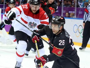 Great attacker, butMarty St. Louis controls the puck from his knees against Austria's Thomas Pock on Friday.
