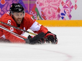 Canada's Shea Weber grimaces as he falls during the Men's Ice Hockey Semifinal match between the USA and Canada at the Bolshoy Ice Dome during the Sochi Winter Olympics on February 21, 2014.