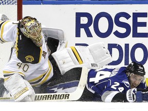Tampa Bay Lightning right-winger Ryan Callahan takes down Boston Bruins goalie Tuukka Rask after he was tripped during a National Hockey League game at Tampa, Fla., on March 8, 2014.