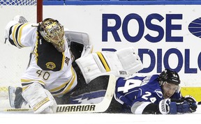 Tampa Bay Lightning right-winger Ryan Callahan takes down Boston Bruins goalie Tuukka Rask after he was tripped during a National Hockey League game at Tampa, Fla., on March 8, 2014.