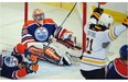 Aftermath: Drew Stafford celebrates his goal that has just clinched Buffalo Sabres' 3-1 victory over Edmonton Oilers on Thursday night. Oilers goaltender Ben Scrivens and right wing (!) David Perron assume unconventional poses at the end of a long sequence of pain.