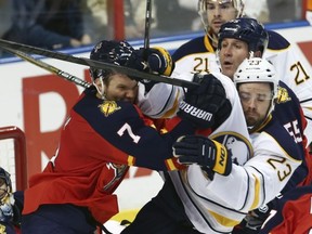 Florida Panthers defenceman Dmitry Kulikov clashes with Buffalo Sabres forward Ville Leino in front of the Florida net during a National Hockey League game at Sunrise, Fla., on March 7, 2014.