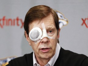 Nashville Predators general manager David Poile wore a patch over his right eye after being hit with a puck during a morning practice before a National Hockey League game in St. Paul, Minn., on Feb. 6, 2014.