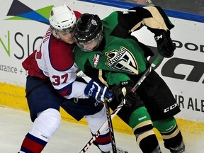 EDMONTON, ALTA: March 22, 2014 -- Edmonton Oil Kings #37 Dysin Mayo and #7 Sawyer Lange of Prince Albert Raiders fight for the puck in the first round of the WHL playoffs at Rexall Place in Edmonton, March 22, 2014. (Ed Kaiser - Edmonton Journal)