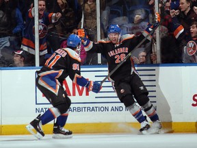 Thomas Vanek (26) of the New York Islanders celebrates his goal with John Tavares at 18:09 of the third period against the Washington Capitals in a National Hockey League game at the Nassau Veterans Memorial Coliseum in Uniondale, N.Y., on Nov. 30, 2013.