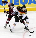 Leon Draisaitl , right, of Germany tries to protect the puck against Latvia's Ronalds Kenins during a world championship game at Minsk, Belarus, on May 11, 2014.