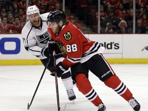 Patrick Kane of the Chicago Blackhawks controls the puck against Jeff Carter of the Los Angeles Kings during a Western Conference final game in Chicago on May 18, 2014.