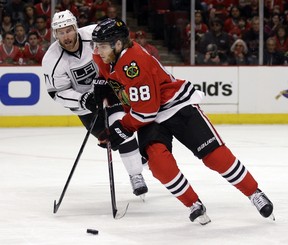 Patrick Kane of the Chicago Blackhawks controls the puck against Jeff Carter of the Los Angeles Kings during a Western Conference final game in Chicago on May 18, 2014.