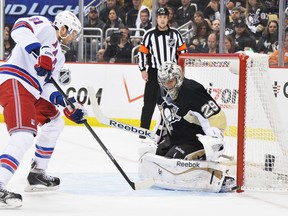 Pittsburgh Penguins goaltender Marc-Andre Fleury makes a pad save on a shot from Rick Nash of the New York Rangers in Game 2 of a second-round NHL playoff series on May 4, 2014, at Consol Energy Center in Pittsburgh.