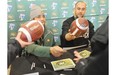 Running back Calvin McCarty and long snapper Ryan King sign autographs for fans at the Edmonton Eskimos locker-room sale at Commonwealth Stadium on Nov. 30, 2013.
Photograph by: Shaughn Butts, Edmonton Journal