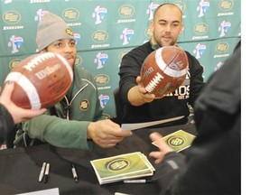 Running back Calvin McCarty and long snapper Ryan King sign autographs for fans at the Edmonton Eskimos locker-room sale at Commonwealth Stadium on Nov. 30, 2013.
Photograph by: Shaughn Butts, Edmonton Journal