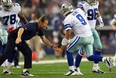 Dallas Cowboys coach Jason Garrett celebrates a touchdown with quarterback Tony Romo.