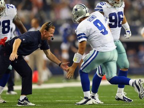 Dallas Cowboys coach Jason Garrett celebrates a touchdown with quarterback Tony Romo.