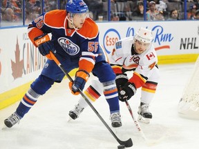 Leon Draisaitl controls the puck and looks for the passing lane.