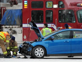 EDMONTON, ALBERTA, JANUARY 30, 2013: It was so cold the firefighters stayed in their truck as much as possible at a 2 vehicle minor collision on very icy streets at 101st-103A Av in Edmonton, Ab on Tuesday Jan.29, 2013. Photo by John Lucas/Edmonton Journal)(standalone)