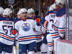 Nail Yakupov and Leon Draisaitl celebrate a goal with Oilers' bench.