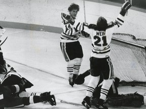 Stan Weir and Blair MacDonald celebrate after a goal on Rogie Vachon in the Oilers first home game as an NHL team
(October 13, 1979;
Ken Orr photo)