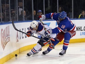 Jordan Eberle protects the puck against Marc Staal.