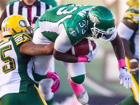 Edmonton Eskimos linebacker Dexter McCoil tackles Saskatchewan Roughriders running back Jerome Messam during a Canadian Football League game at Mosaic Stadium in Regina on Oct. 19, 2014.
Photograph by: Liam Richards, THE CANADIAN PRESS