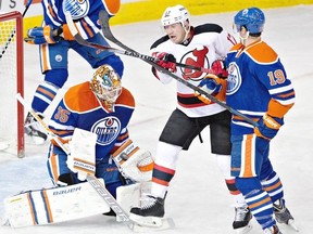 New Jersey Devils' Michael Ryder (17) battles in front of the net with Edmonton Oilers' Justin Schultz (19) as goalie Viktor Fasth (35) makes the save during second period NHL hockey action in Edmonton, on Friday November 21, 2014. THE CANADIAN PRESS/Jason Franson
