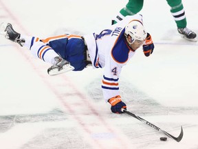 Taylor Hall crashes to the ice after being viciously kneed by Ryan Garbutt of Dallas Stars. Hall's Oilers also crashed to a 3-2 regulation defeat.
