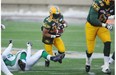 Esk RB John White hits an opening in the Rider line during the Western Semi Final game in Commonwealth Stadium in Edmonton on Sunday Nov 16, 2014.
Photograph by: John Lucas, Edmonton Journal