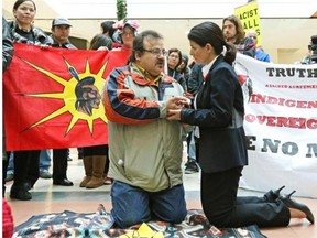 Aboriginal outreach worker Gary Moostoos and Olympia Trencevski, general manager of City Centre Mall, hold hands during an organized dance/rally at the mall. Moostoos had been kicked out and banned from the premises by security guards for no apparent reason while he was eating at the food court. Mall administration has since apologized and rescinded the ban.