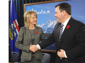 After announcing a renewed federal Gas Tax Fund Agreement, Jason Kenney, federal Employment minister, shakes hands with Diana McQueen, Municipal Affairs minister, at the Alberta Legislature on Nov. 10, 2014.