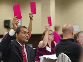 Alberta Liberal Leader Raj Sherman casts his vote on an amendment during the 2014 policy convention held at the Chateau Nova Hotel  on Saturday, Sept. 27, 2014.