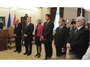 New Alberta Premier Jim Prentice introduces new ministers (from L- Stephen Mandel, Rod McIvor, Maureen Kubinec, Stephen Khan, Gordon Dirks and David Dorward) during the swearing in ceremony for him and new cabinet ministers at Government House in Edmonton on Monday Sept. 15, 2014.