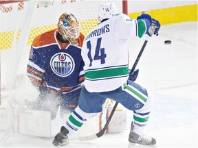 Alex Burrows is stopped by Edmonton Oilers goalie Viktor Fasth in pre-season action last week. The Vancouver Canucks forward will surely improve on the five goals he had in 2013-14.