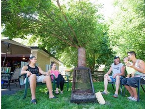 Alex Richardson (left) Meggan Romphf, Joe Richardson, Kevin Lam, and Olivia Lam, four-months old, sit around the same fire pit where seven EPS officers and the Air-1 helicopter showed up Monday night due to a noise complaint in late July.