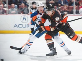 Andrew Cogliano of the Anaheim Ducks tries to get past Edmonton Oilers defenceman Jeff Petry during Wednesday’s National Hockey League game at the Honda Center in Anaheim on Wednesday.