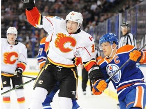Andrew Ference of the Edmonton Oilers collides with Ladislav Smid of the Calgary Flames in preseason NHL action at Rexall Place in Edmonton.
