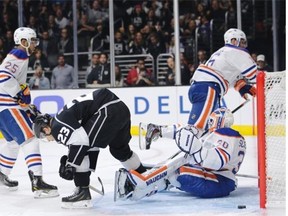 Los Angeles Kings’ Dustin Brown (23) scores against Edmonton Oilers goalie Ben Scrivens (30) during the second period of an NHL hockey game Tuesday, Oct. 14, 2014, in Los Angeles.