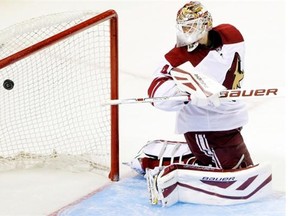 Arizona Coyotes goalie Devan Dubnyk is beaten for a goal on a shot from San Jose Sharks center Joe Pavelski during the second period of an NHL preseason hockey game Friday, Sept. 26, 2014, in San Jose, Calif.