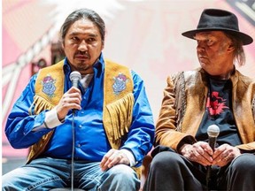 Athabasca Chipewyan Chief Allan Adam, left, and singer-songwriter Neil Young attend a news conference for the Honour the Treaties tour, a series of benefit concerts held to raise money for legal fight against the expansion of the Athabasca oilsands in northern Alberta and other similar projects, in Toronto on Jan. 12, 2014. Mark Blinch/The Canadian Press/File
