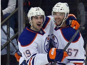 Benoit Pouliot, right, celebrates his goal at 8:29 of the second period against the New York Rangers with defenceman Justin Schultz in a National Hockey League game at Madison Square Garden in New York on Nov. 9, 2014.