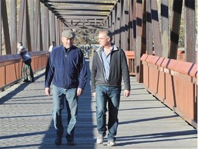Bill Moore-Kilgannon, right, president of the Riverdale Community League, and Paul Bunner, civics director for the Cloverdale Community League, on the Cloverdale footbridge where the new LRT will be crossing the river. Many community groups are frustrated at the lack of detail in the request for proposals for the Valley Line LRT.