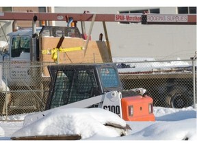 A Bobcat sits in the yard at Spar-Marathon Roofing Supplies in Edmonton on Tuesday December 2, 2014. A man died early Tuesday morning after being crushed by the bucket of a Bobcat at this location.