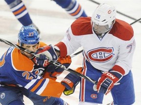 Boyd Gordon, left, of the Edmonton Oilers, takes a stick to the face from P.K. Subban of the Montreal Canadiens at Rexall Place in Edmonton on Thursday, Oct. 11, 2013.