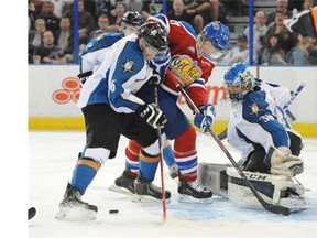 Brandon Ralph of the Edmonton Oil Kings is unable to handle a loose puck Saturday in front of goalie Wyatt Hoflin of the Kootenay Ice at Rexall Place in Edmonton.