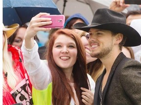 Brett Kissel takes a photo with some fans while traveling down the green carpet during the CCMA awards on Sept. 7, 2014.