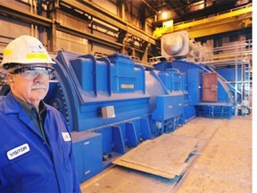 Brian Vaasjo, president and CEO of Capital Power, with the Genesee 3 turbine and generator unit.