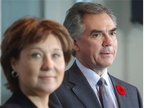 British Columbia Premier Christy Clark, left, and Alberta Premier Jim Prentice listen during a news conference after a meeting at the premier’s office in Vancouver, B.C., on Monday Nov. 3, 2014. THE CANADIAN PRESS/Darryl Dyck